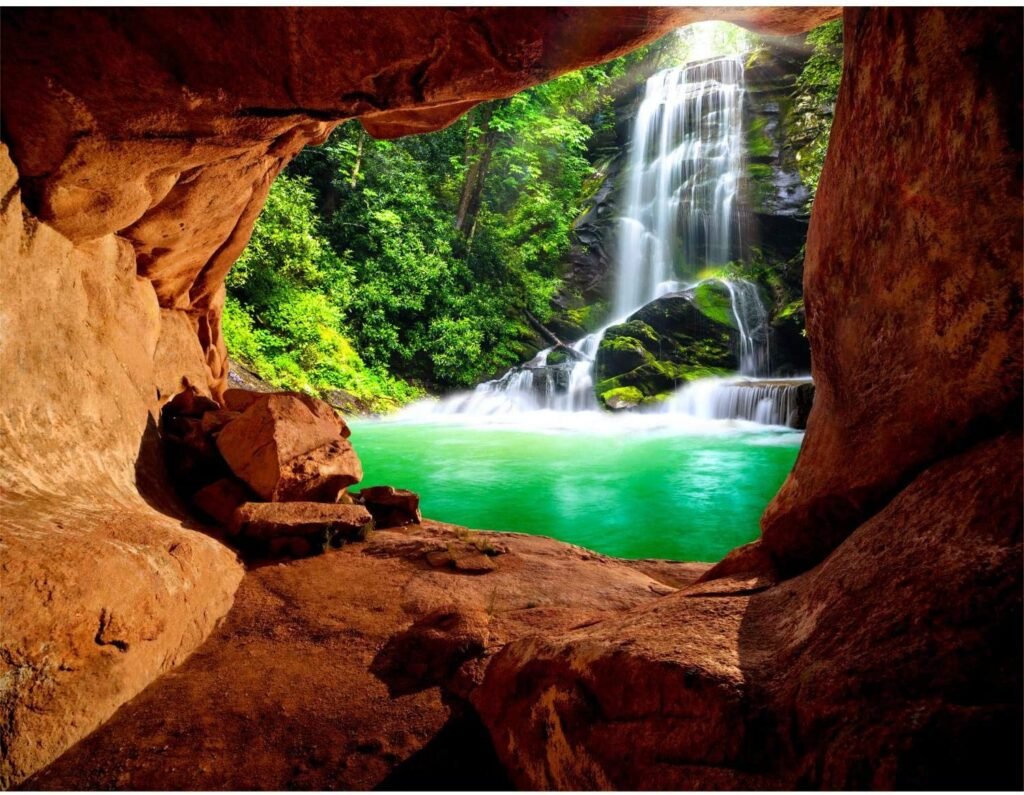 fotomural de cueva con vistas a una cascada con lago.